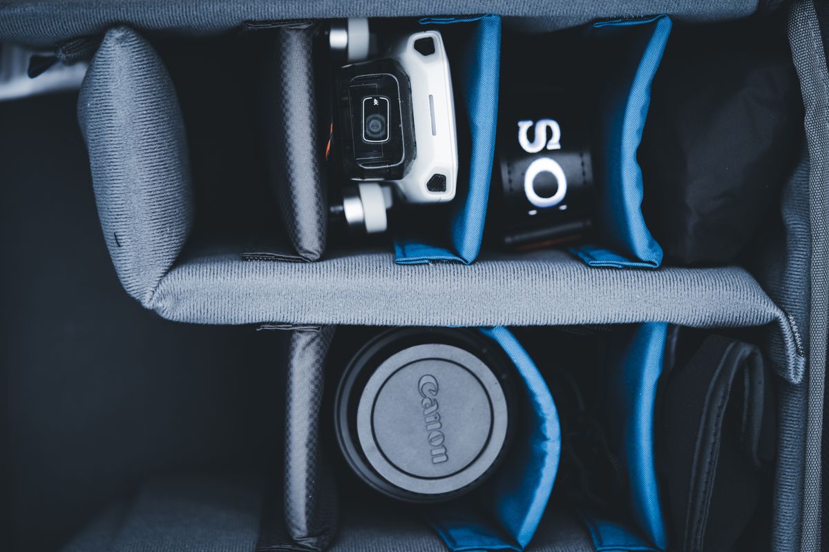 Electronics and camera accessories organized inside a backpack