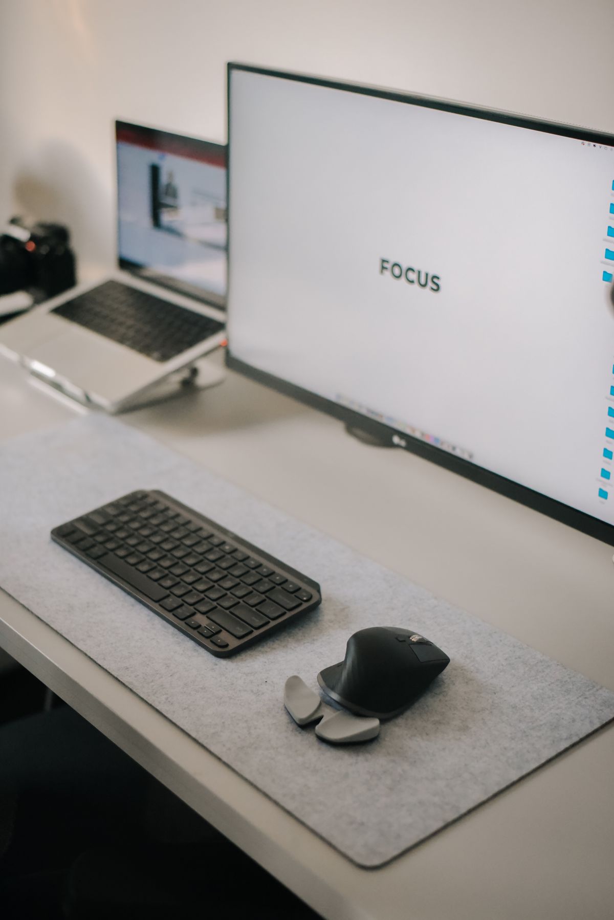 A light home workspace with computer displays and a keyboard