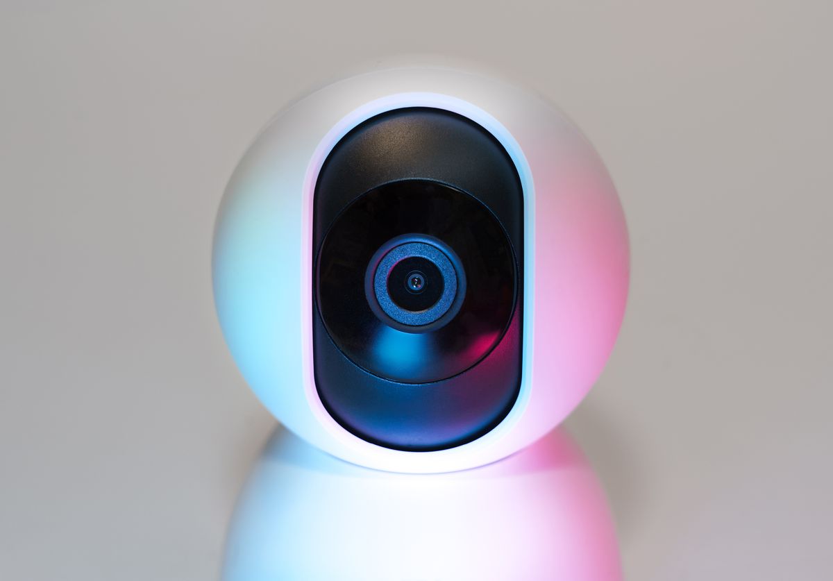 An indoor security camera in soft colored light