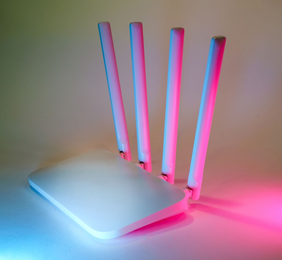 A wireless router photographed with colored lighting