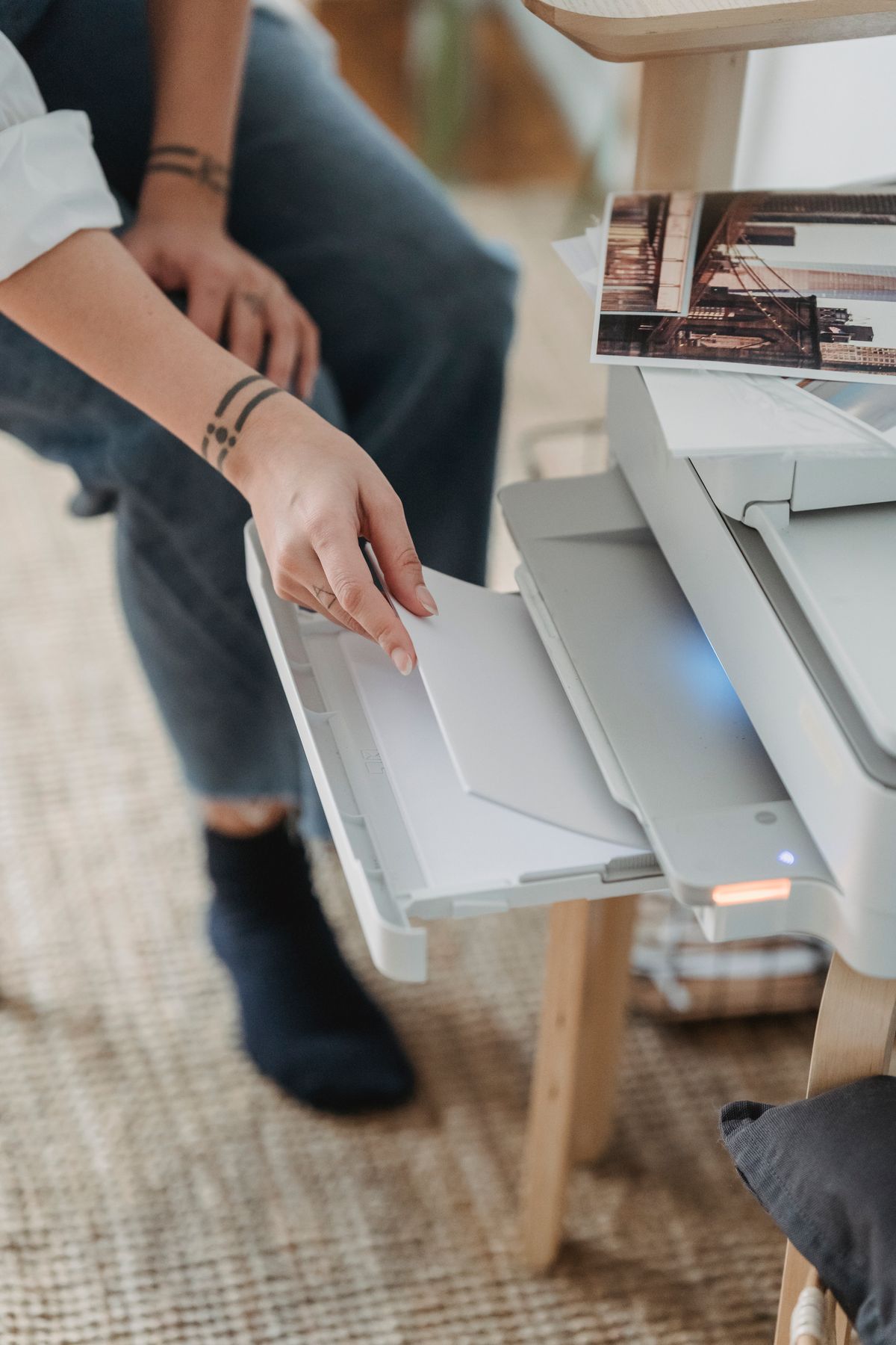 A person loading paper into a home office printer