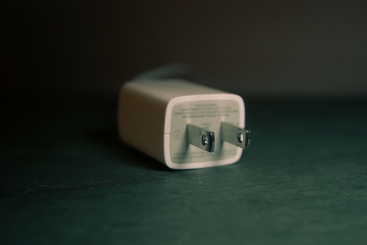 A wall charger plug lying on its side indoors